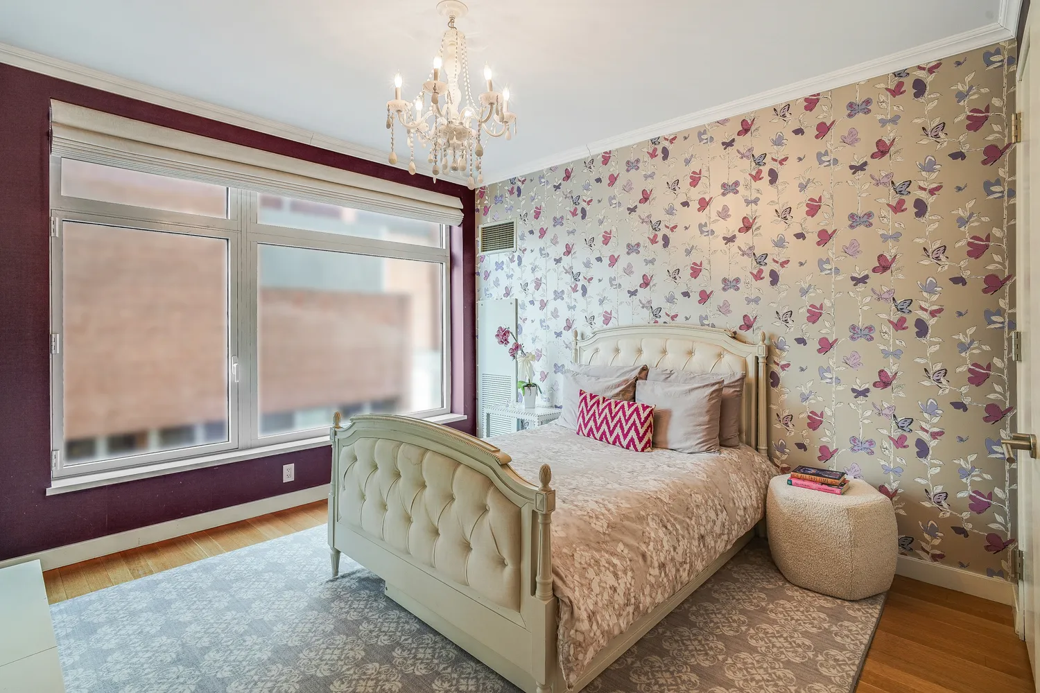 a bedroom with a bed and a chandelier