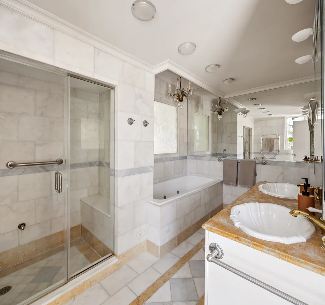 a bathroom with a granite countertop sink mirror bathtub and shower