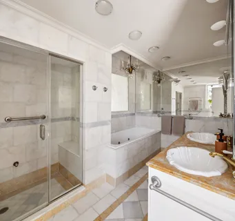 a bathroom with a granite countertop sink mirror bathtub and shower