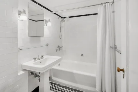 a bathroom with a sink a mirror and a shower