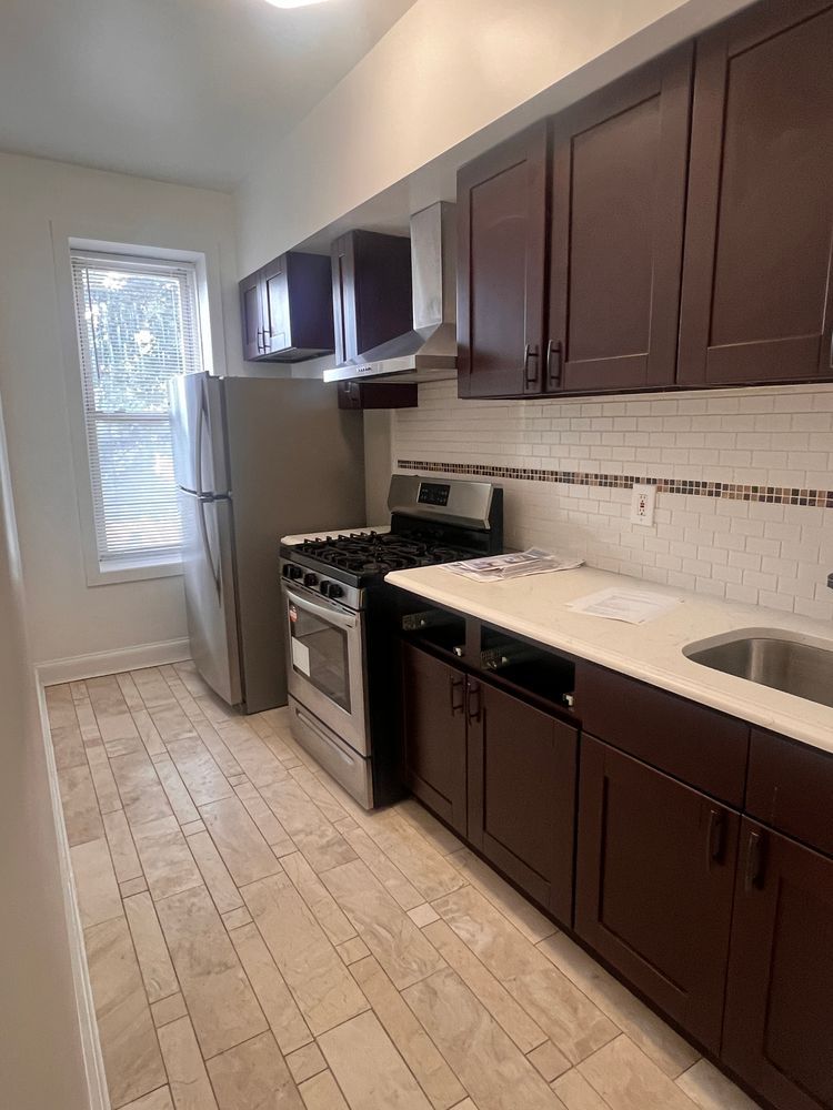 a kitchen with a sink stove and cabinets