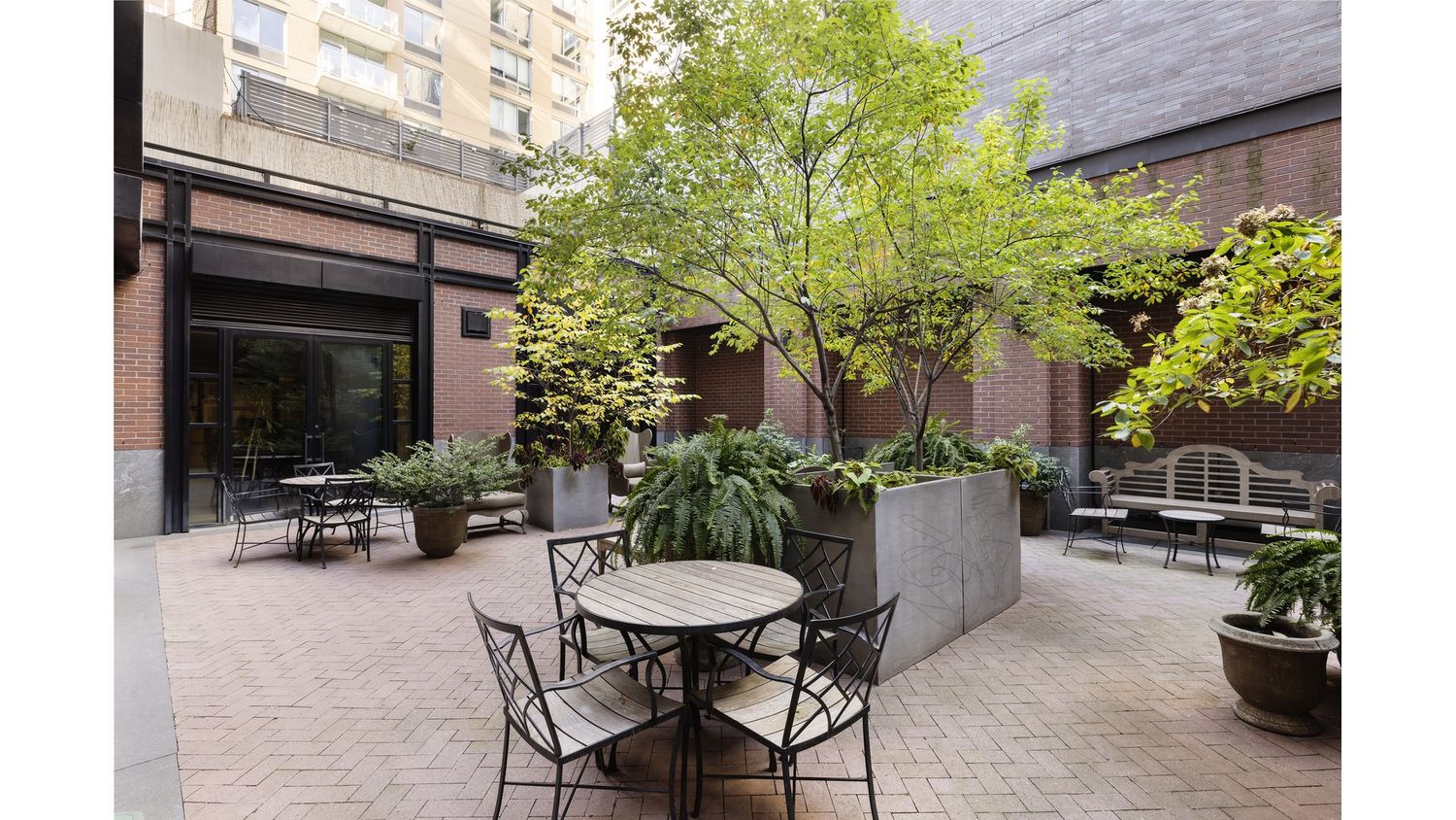 261 West 25th Street, Unit 4A Manhattan, NY 10001 - Photo 12 of 16 a view of a patio with table and chairs potted plants with wooden fence