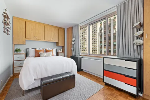 a bedroom with a bed and window