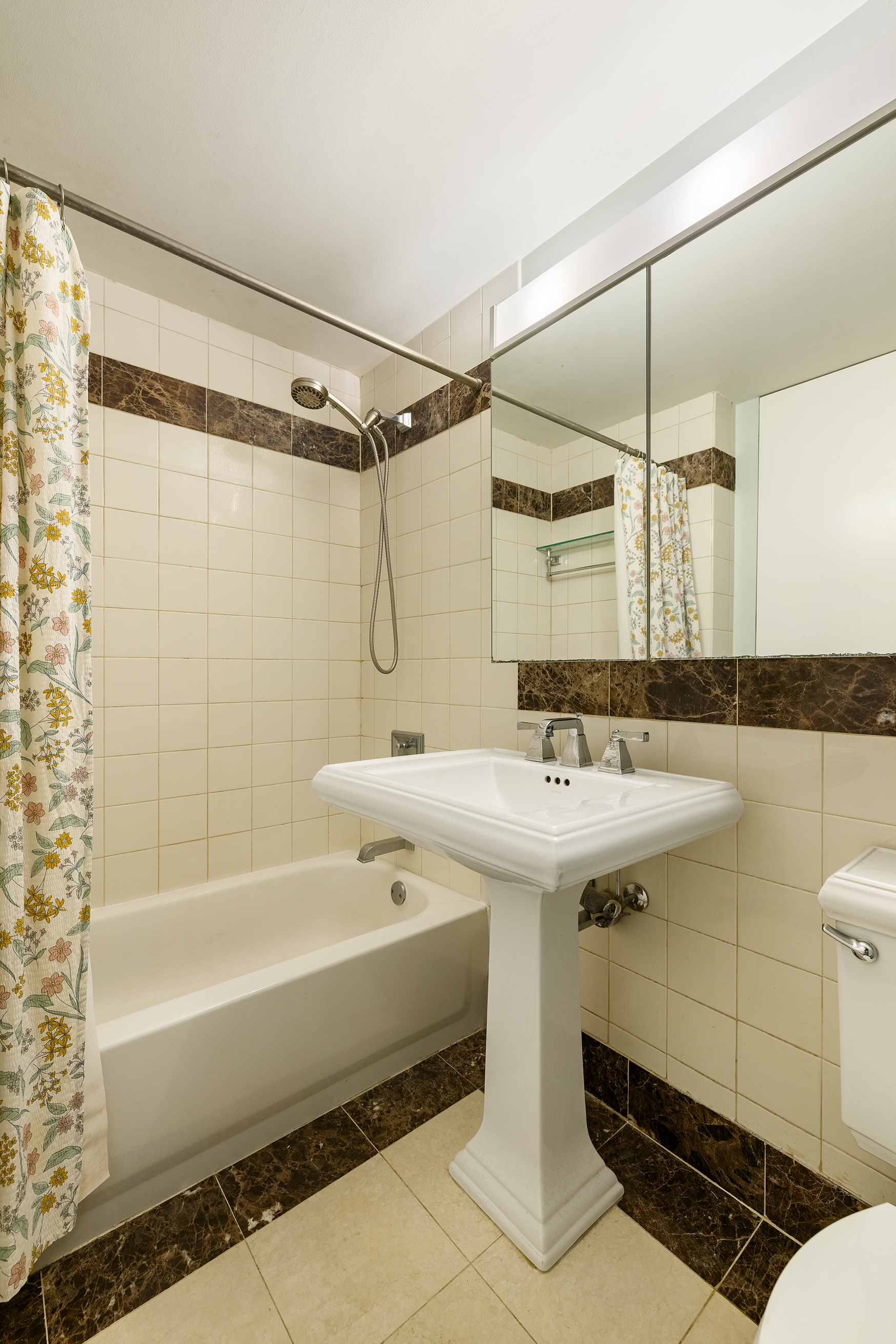 455 Main Street, Unit 4GH Manhattan, NY 10044 - Photo 7 of 9 a bathroom with a sink and a bathtub