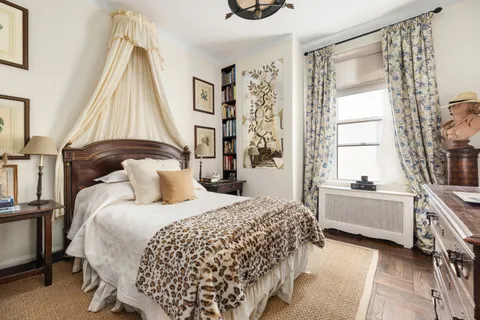 a bedroom with a bed and a large window