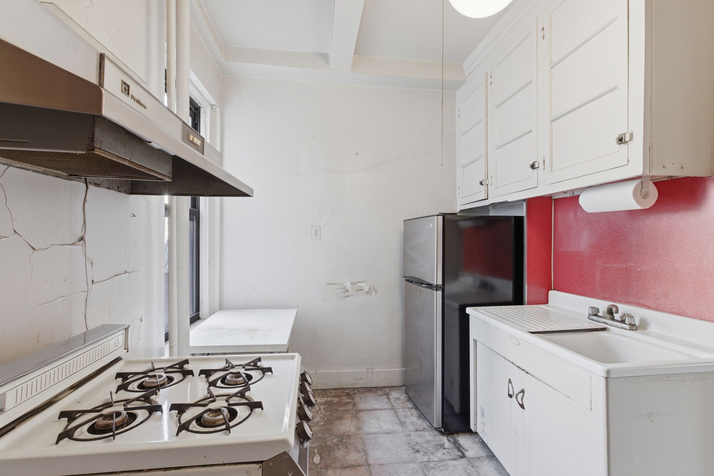 210 West 78th Street, Unit 8C Manhattan, NY 10024 - Photo 8 of 21 a kitchen with a sink appliances and cabinets