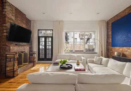 a living room with fireplace furniture and a flat screen tv