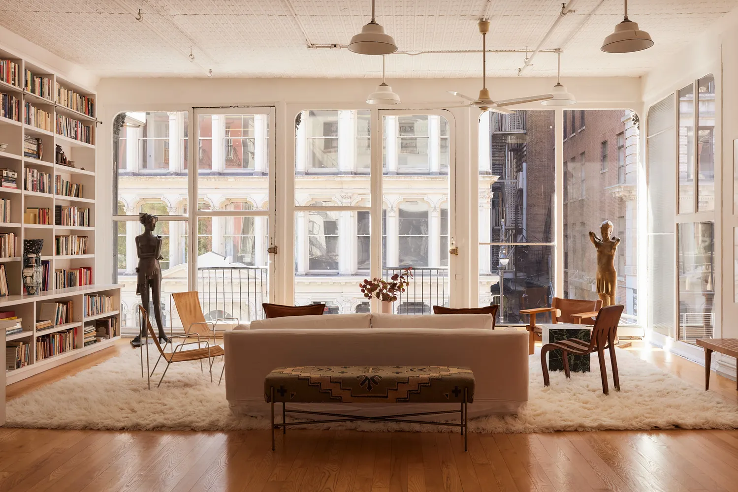 a living room with furniture and a floor to ceiling window