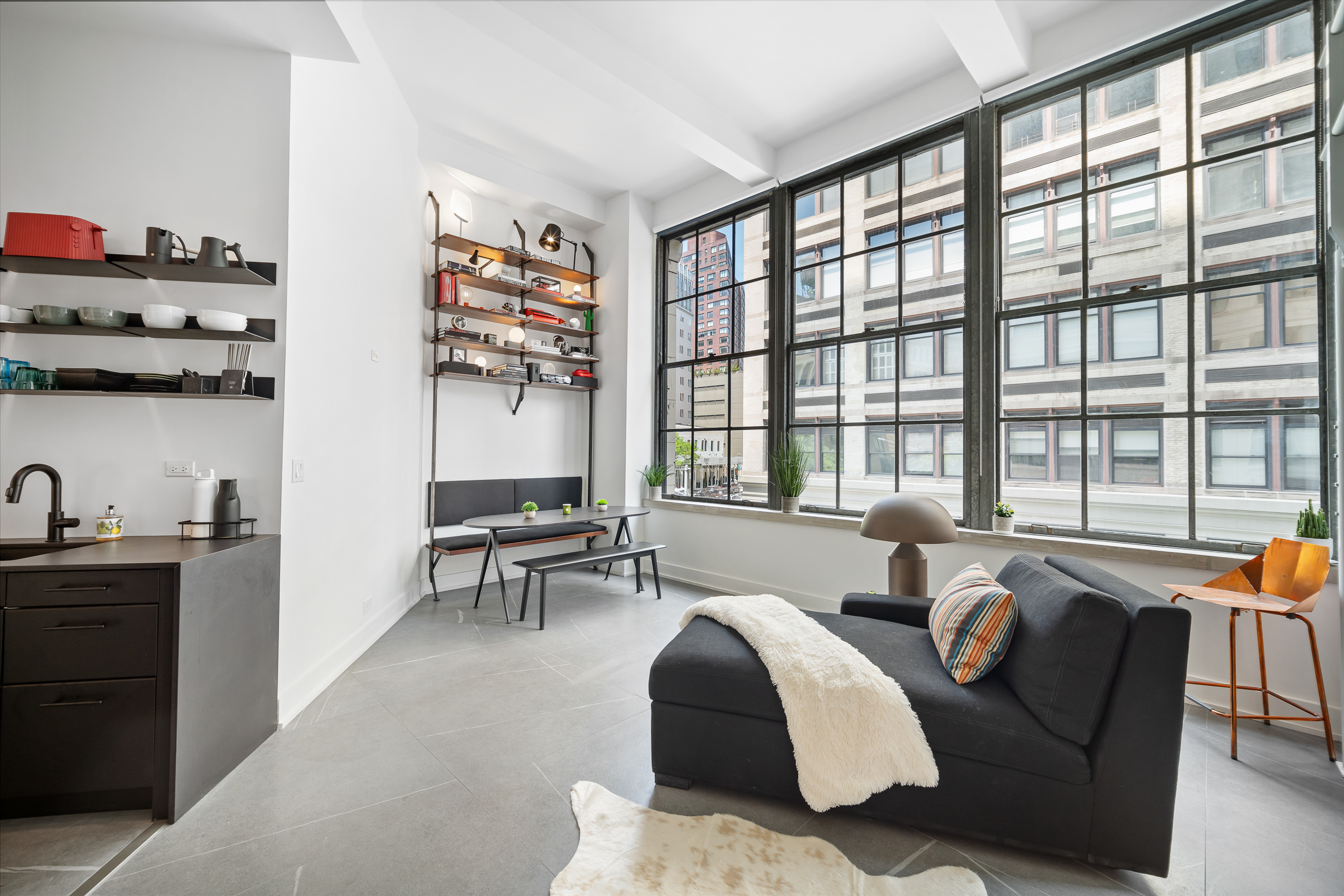 111 4th Avenue, Unit 1J Manhattan, NY 10003 - Photo 3 of 11 a living room with furniture and a large window