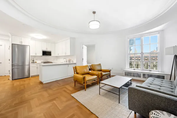 a living room with furniture and kitchen view