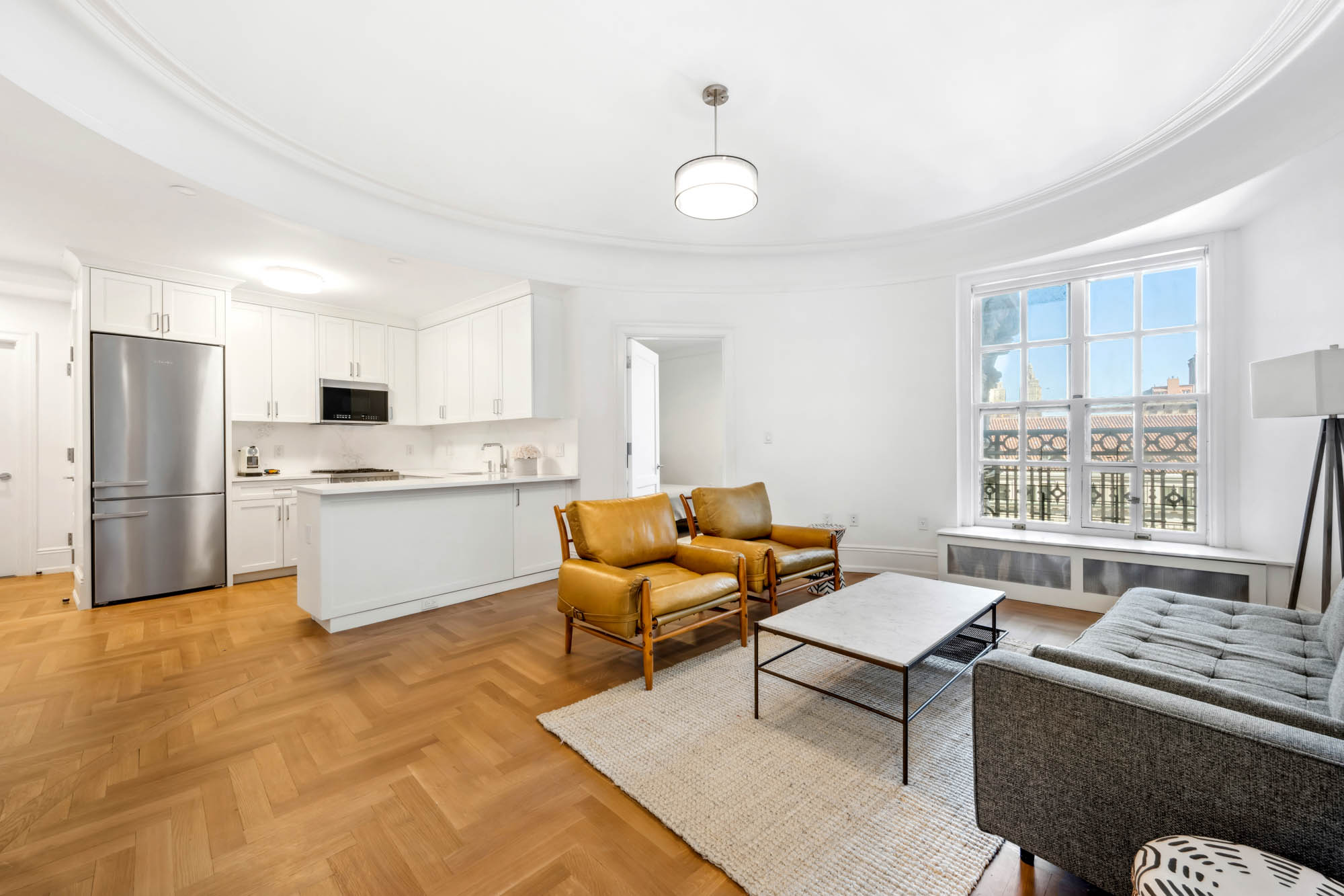 a living room with furniture and kitchen view