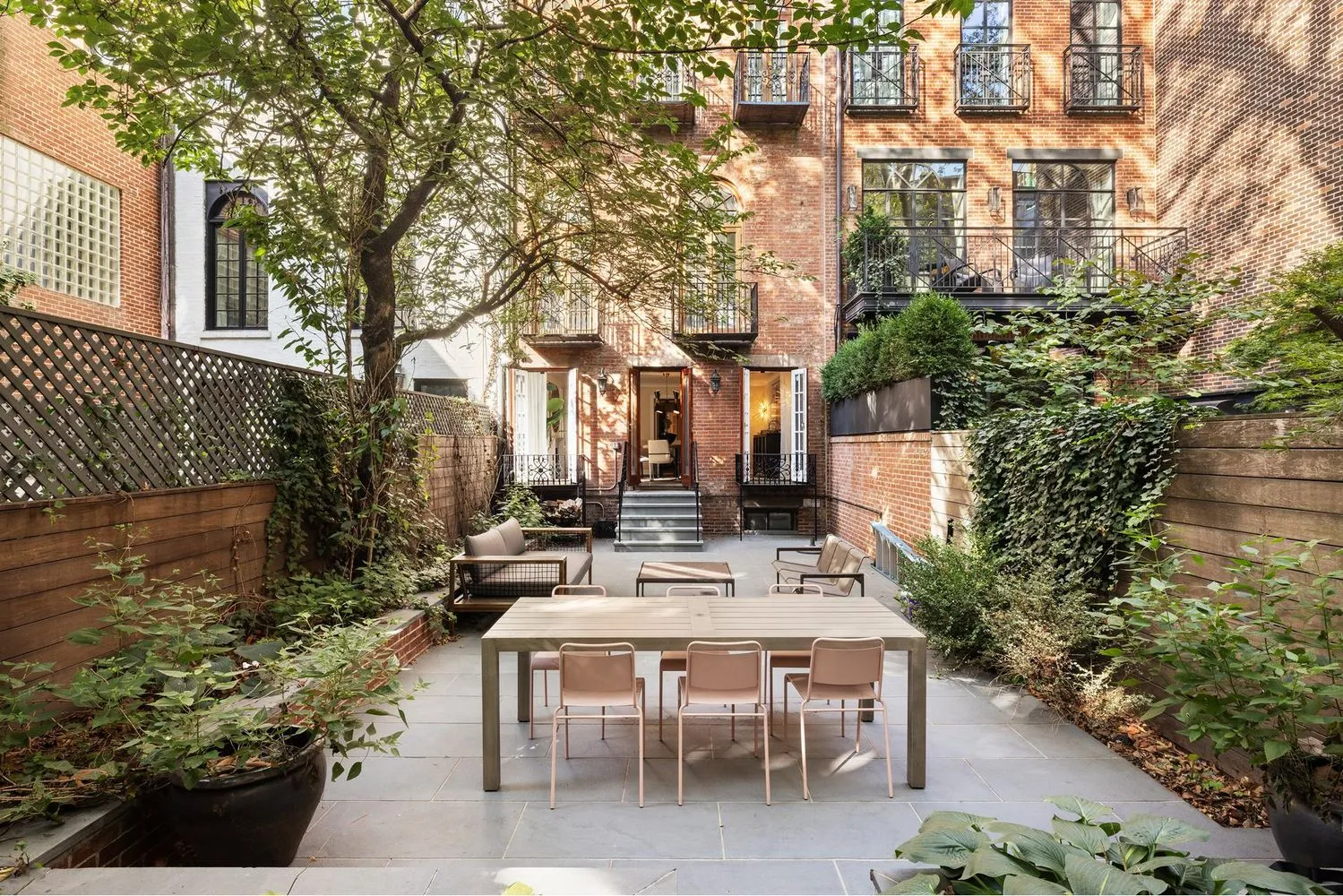 a view of a patio with table and chairs and potted plants