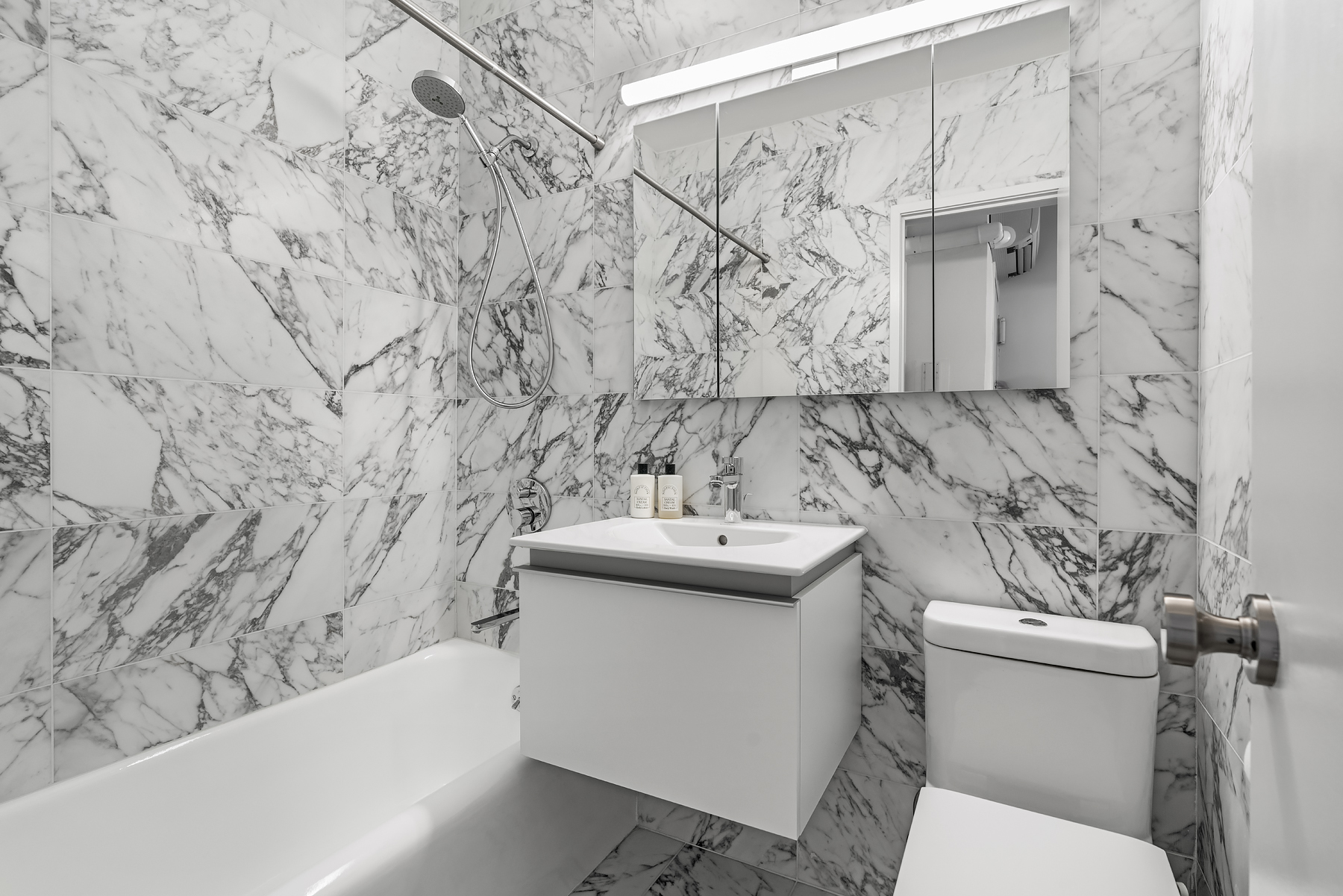 354 West 12th Street, Unit 5B Manhattan, NY 10014 - Photo 5 of 7 a bathroom with a sink and mirror with toilet