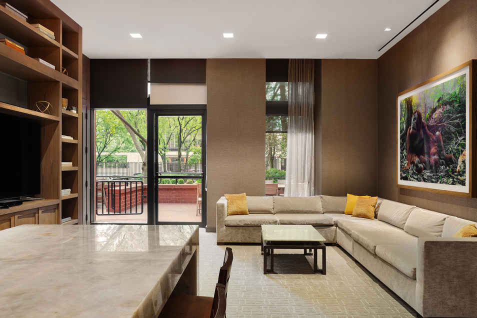 200 East 94th Street, Unit 615 Manhattan, NY 10128 - Photo 7 of 11 a living room with furniture tv and a large window