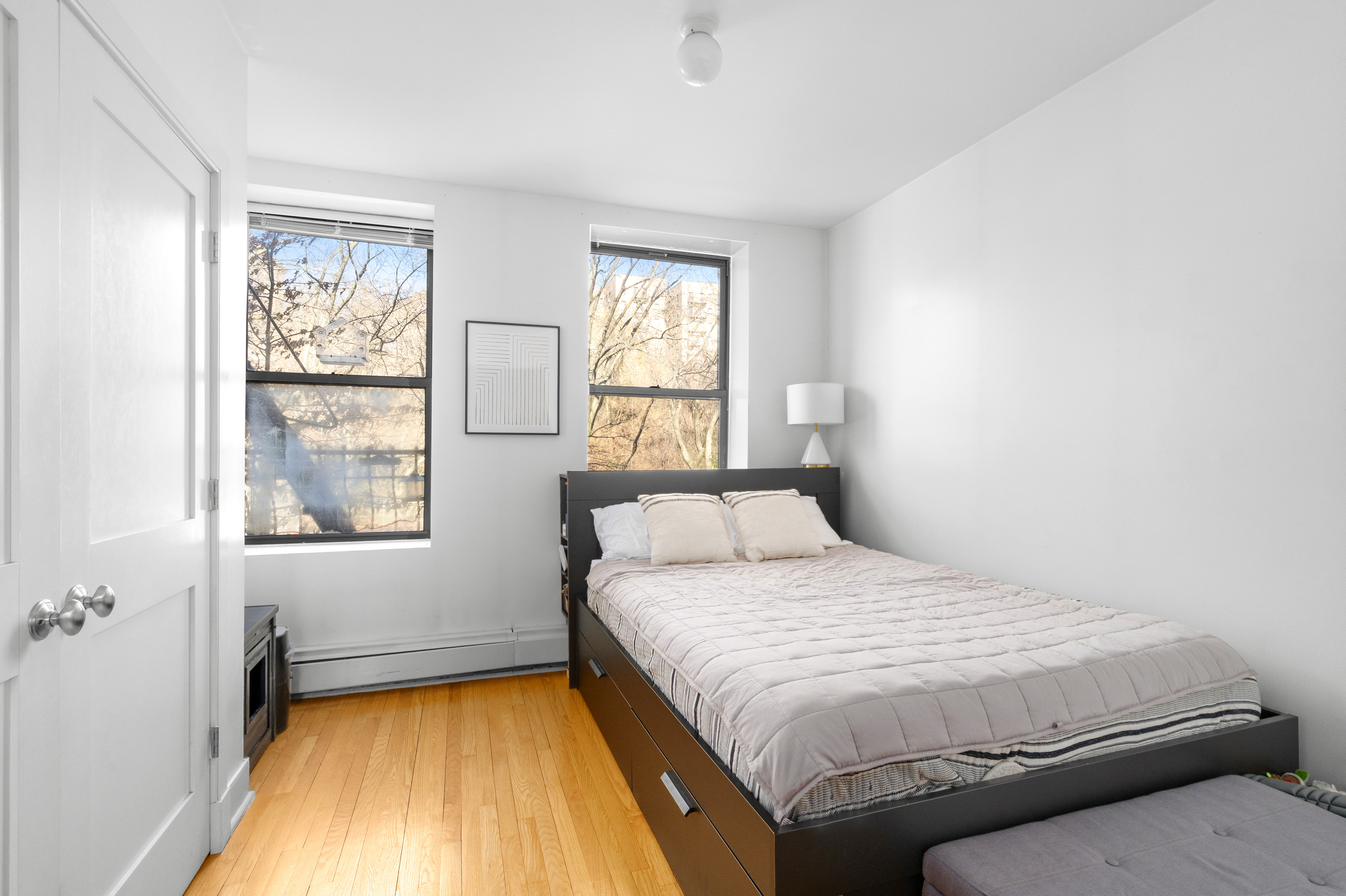 305 West 150th Street, Unit 304 Manhattan, NY 10039 - Photo 4 of 5 a bedroom with a bed and wooden floor