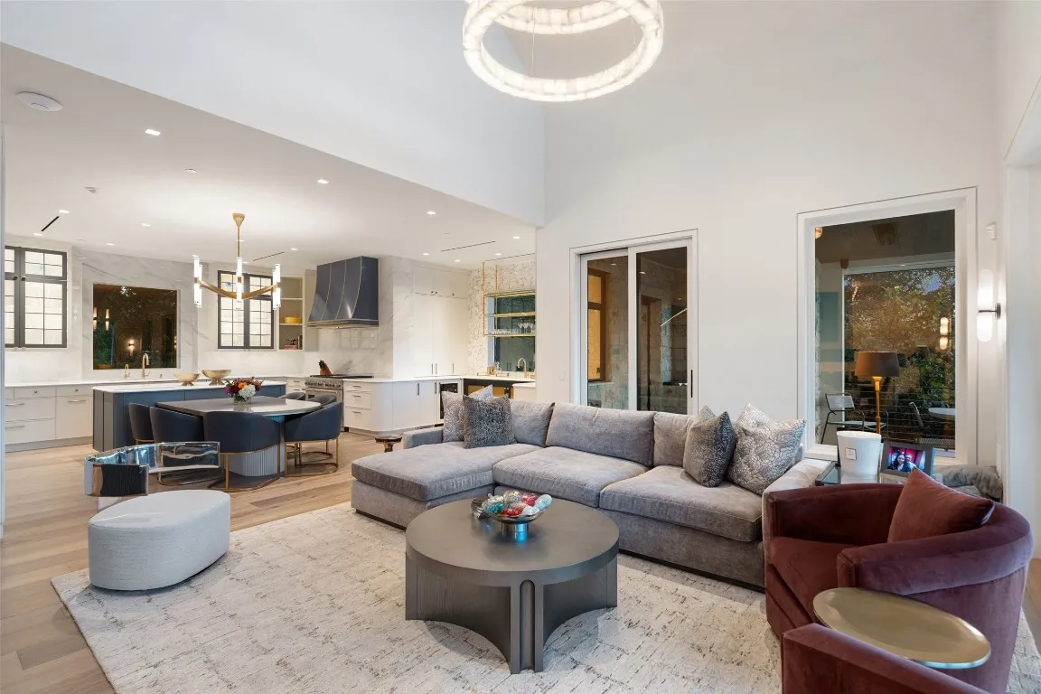 a front view of a house with garden and trees