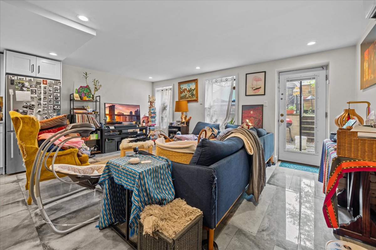 1509 Dean Street, Unit MULTI Brooklyn, NY 11213 - Photo 4 of 12 a living room with furniture a flat screen tv and a window