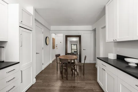 a view of a a dining table and chairs in the kitchen
