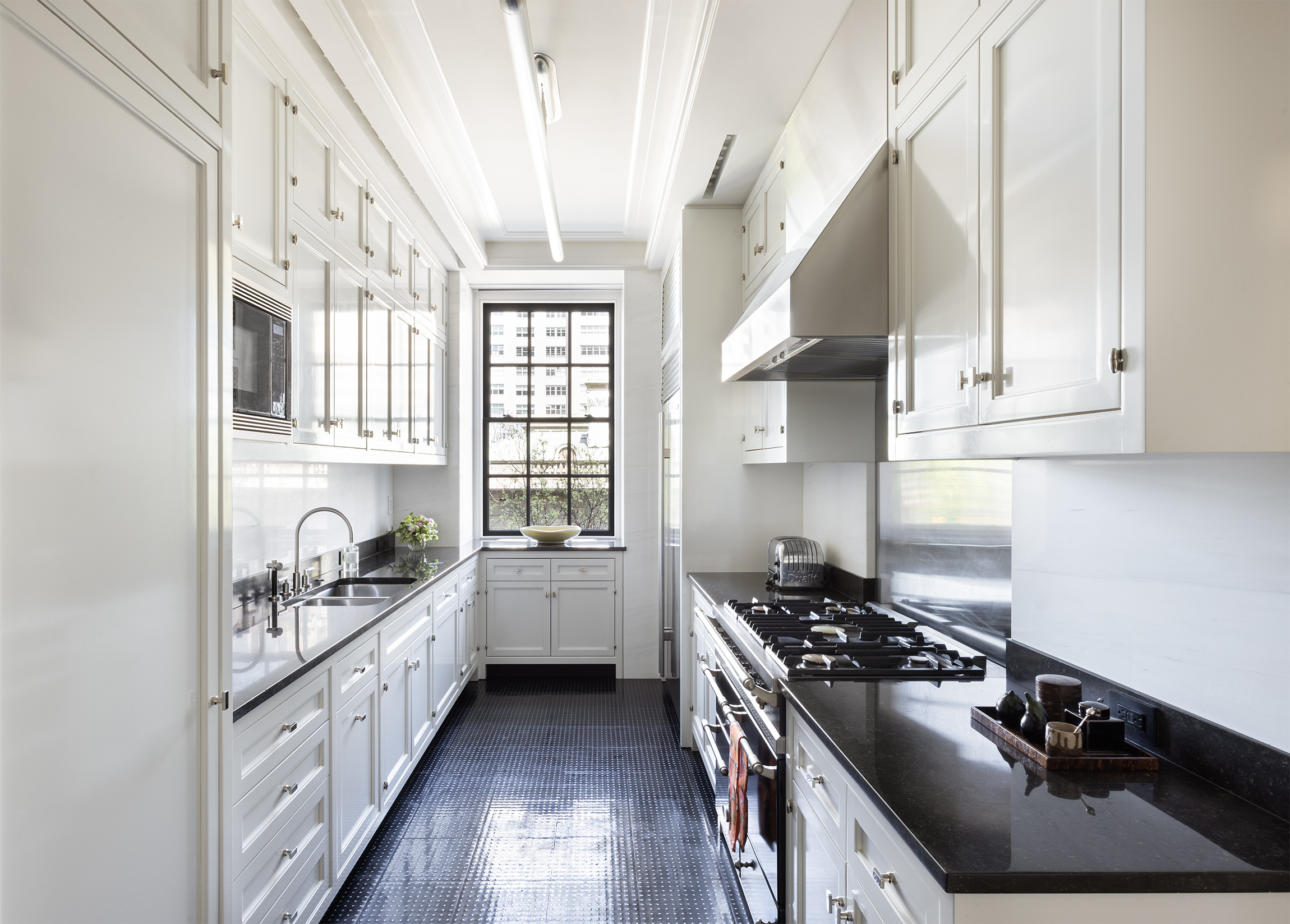 2 East 70th Street, Unit 4A Manhattan, NY 10021 - Photo 11 of 17 a kitchen with stainless steel appliances a sink stove and cabinets
