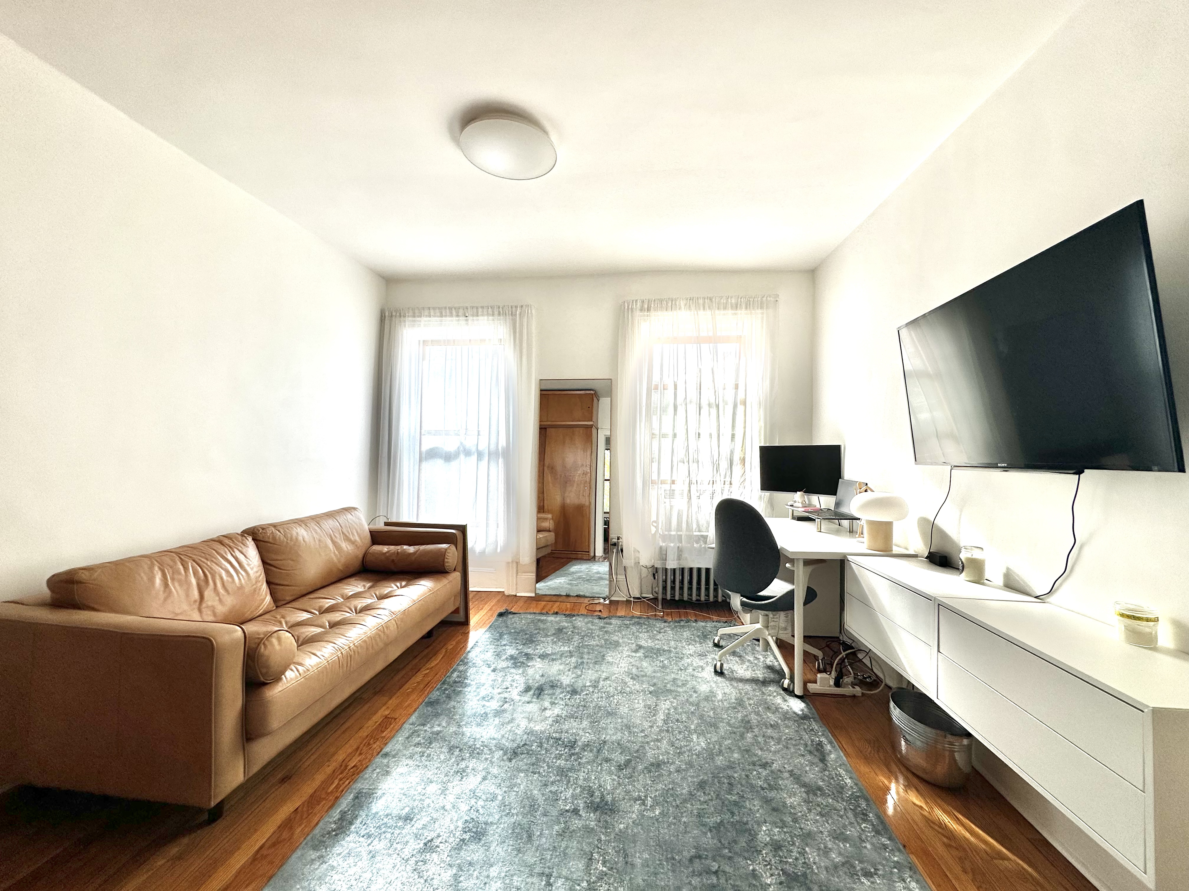 85 Bergen Street, Unit 2C Brooklyn, NY 11201 - Photo 3 of 6 a living room with furniture and a flat screen tv