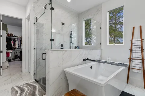 a bathroom with a sink a mirror and a shower