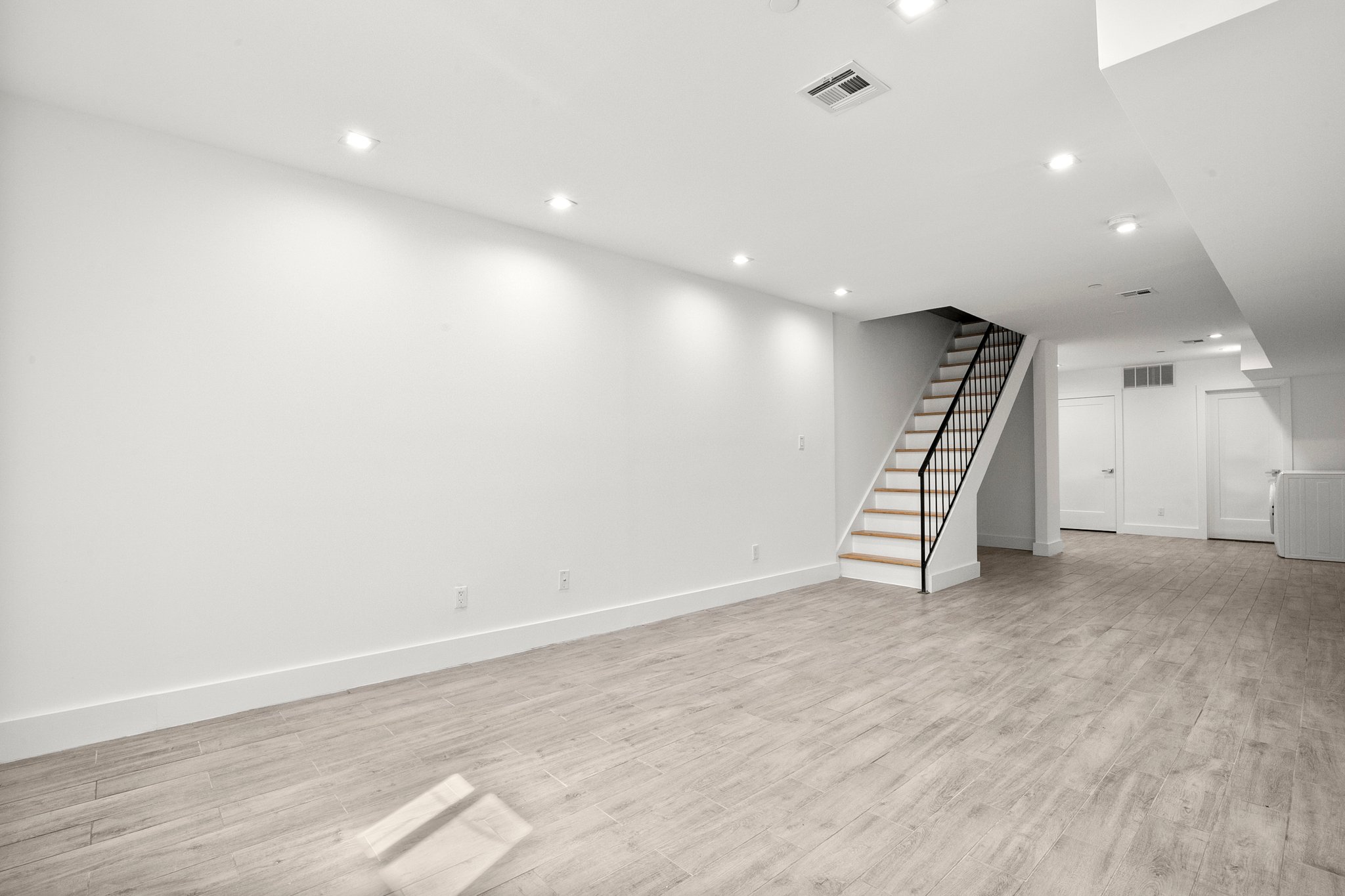 1130 Decatur Street Brooklyn, NY 11207 - Photo 19 of 24 an empty room with wooden floor and white walls
