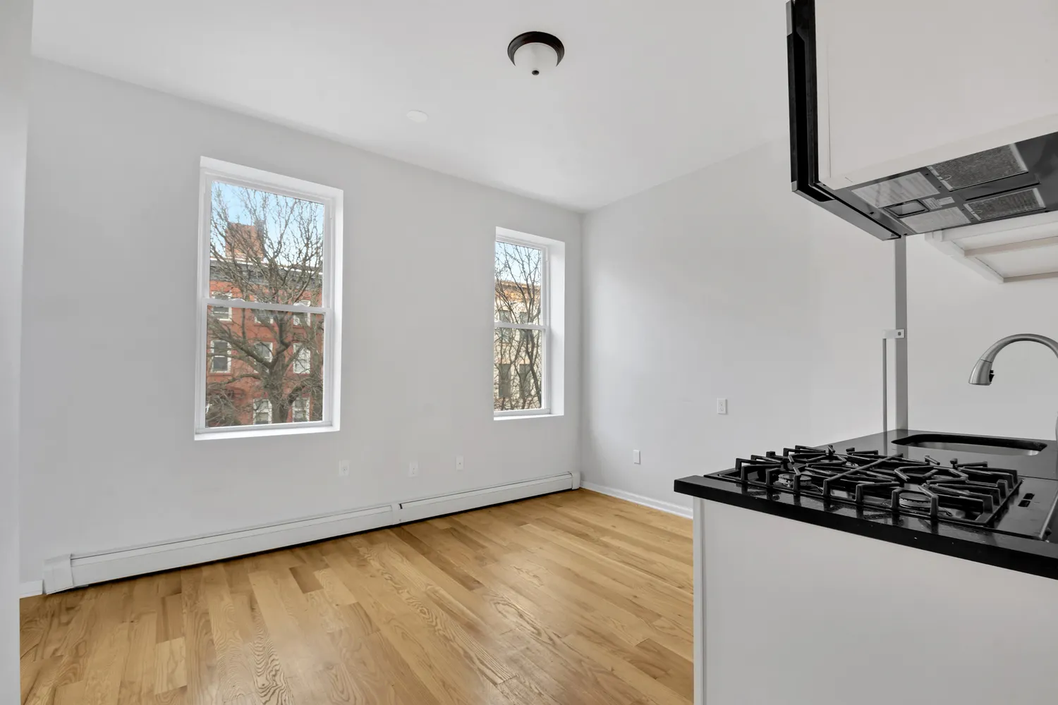 a view of a sink and dishwasher with wooden floor