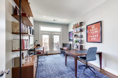 a work room with furniture and a book shelf