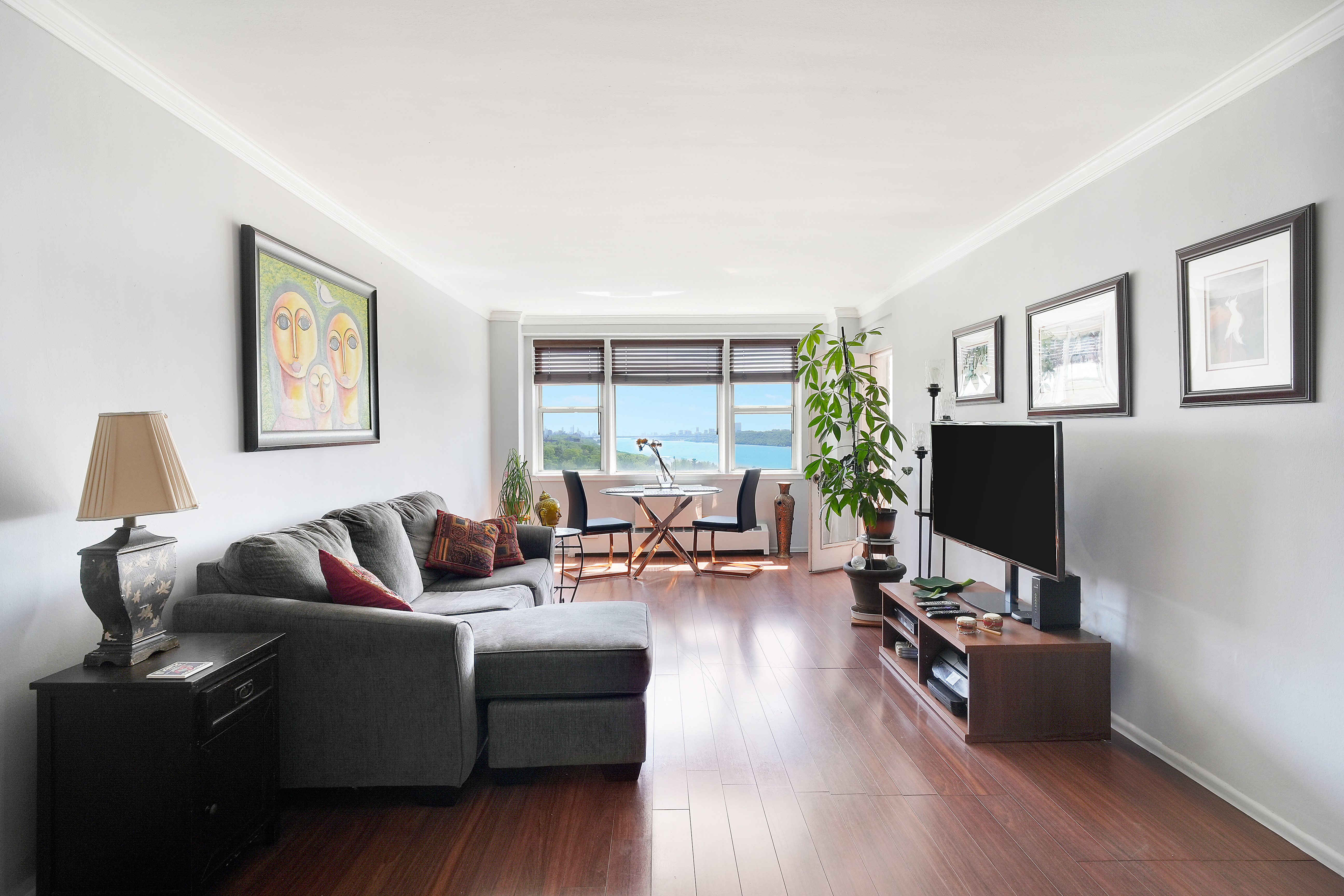 5700 Arlington Avenue, Unit 16T Bronx, NY 10471 - Photo 3 of 16 a living room with furniture and a flat screen tv