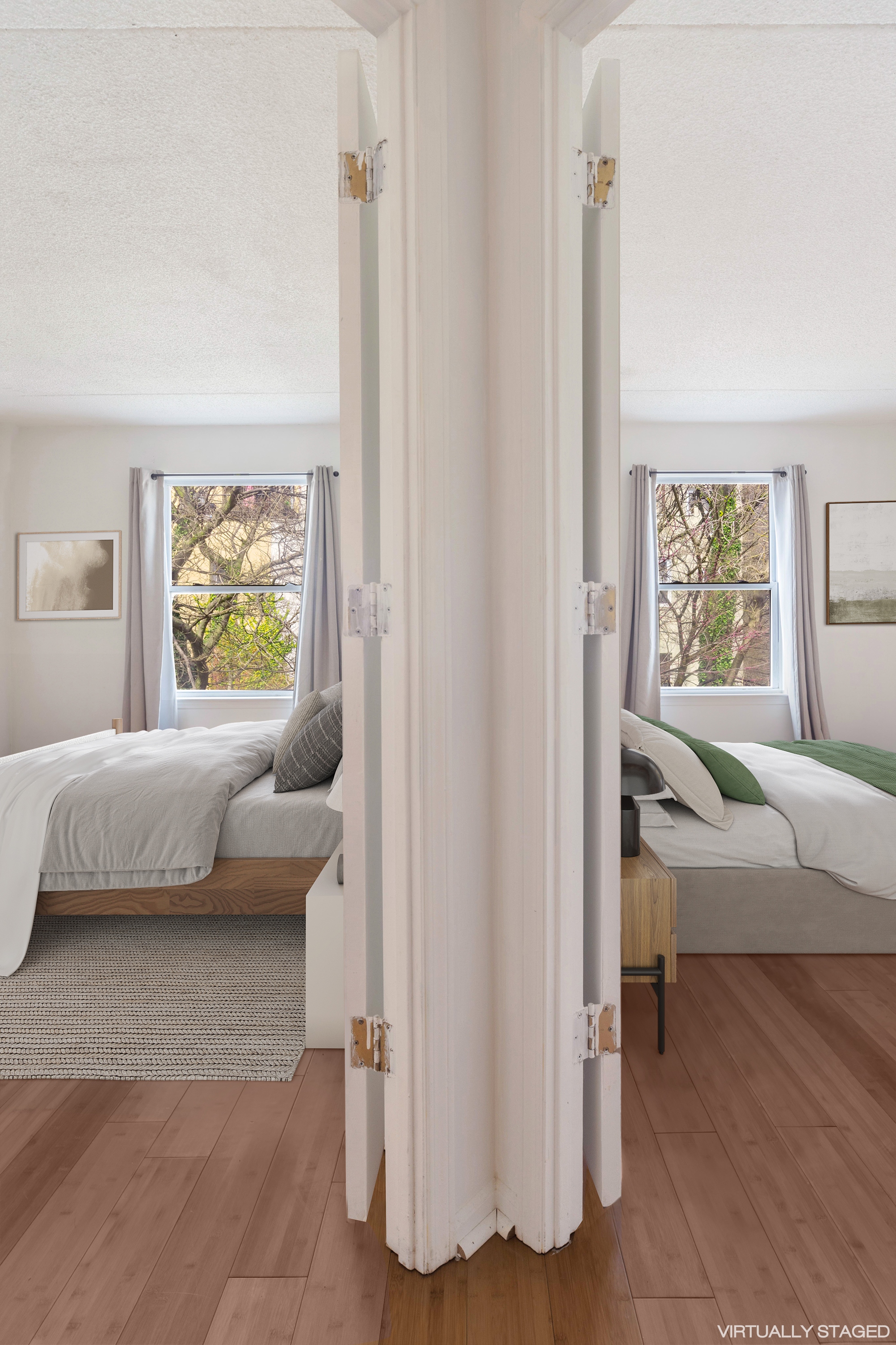 125 West 117th Street Manhattan, NY 10026 - Photo 19 of 23 a bedroom with a bed and a couch next to a window
