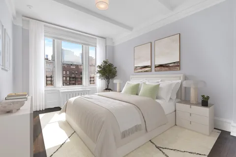 a bedroom with a large bed and a window