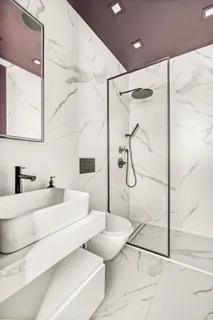 a bathroom with a double vanity sink mirror and shower