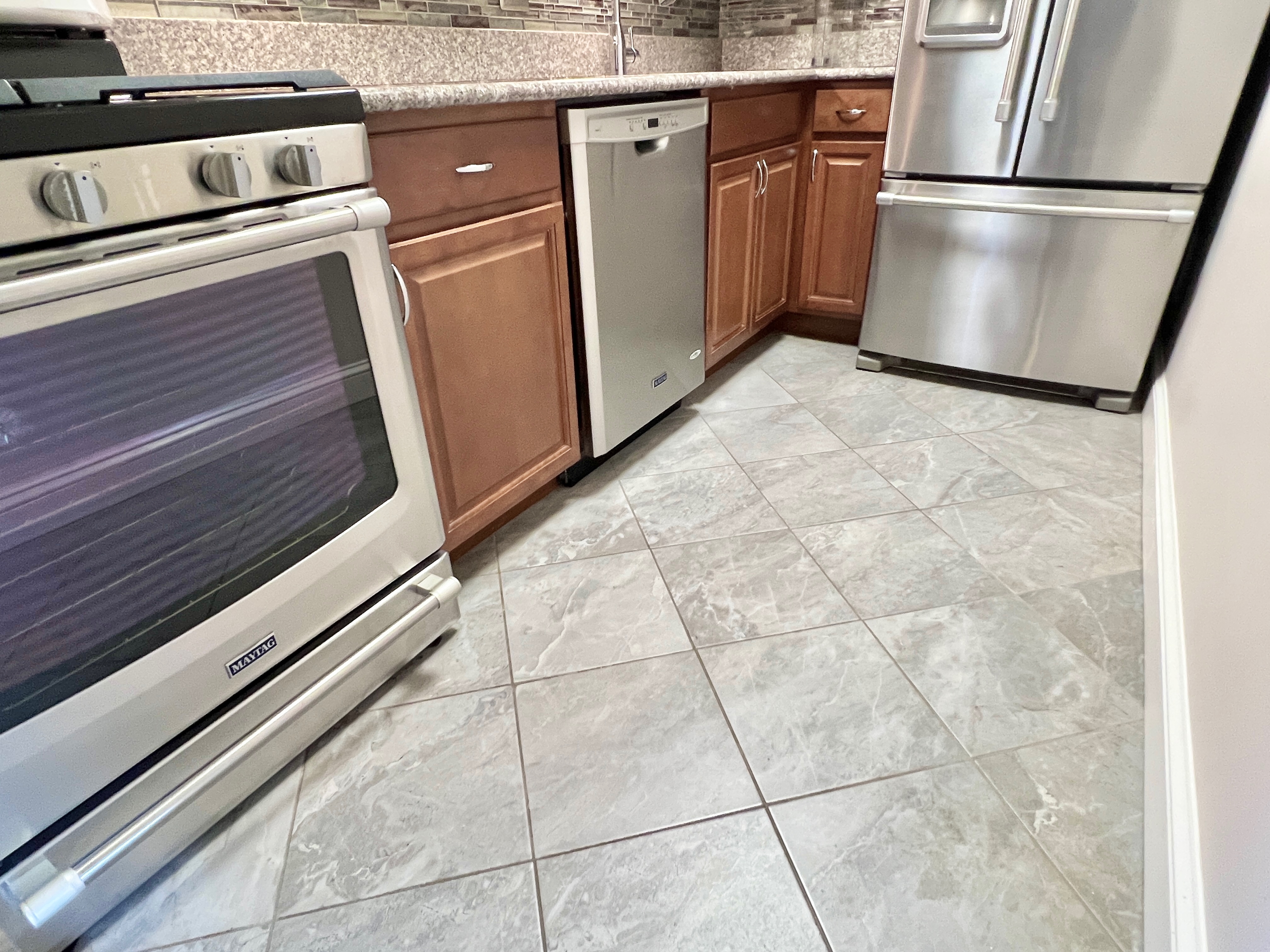490 M Street Southwest, Unit W304 Washington, DC 20024 - Photo 16 of 36 a kitchen with a stove top oven and cabinets