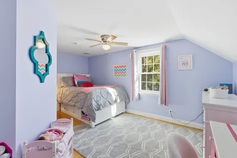 a spacious bedroom with a bed and a window