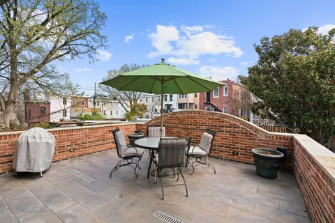 a view of backyard with seating space and trees