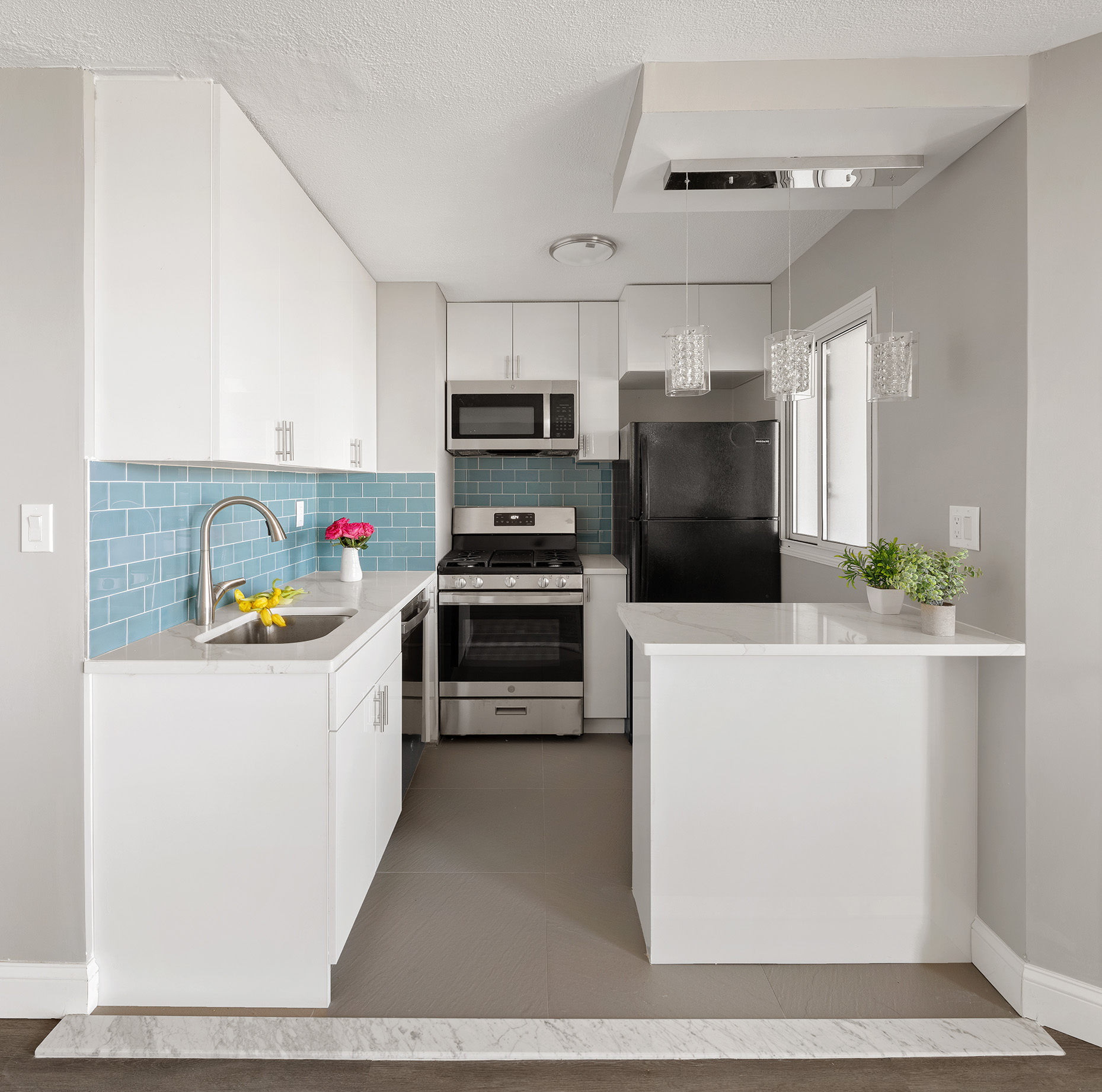 75 Henry Street, Unit 21C Brooklyn, NY 11201 - Photo 3 of 11 a kitchen with a refrigerator a stove and a sink