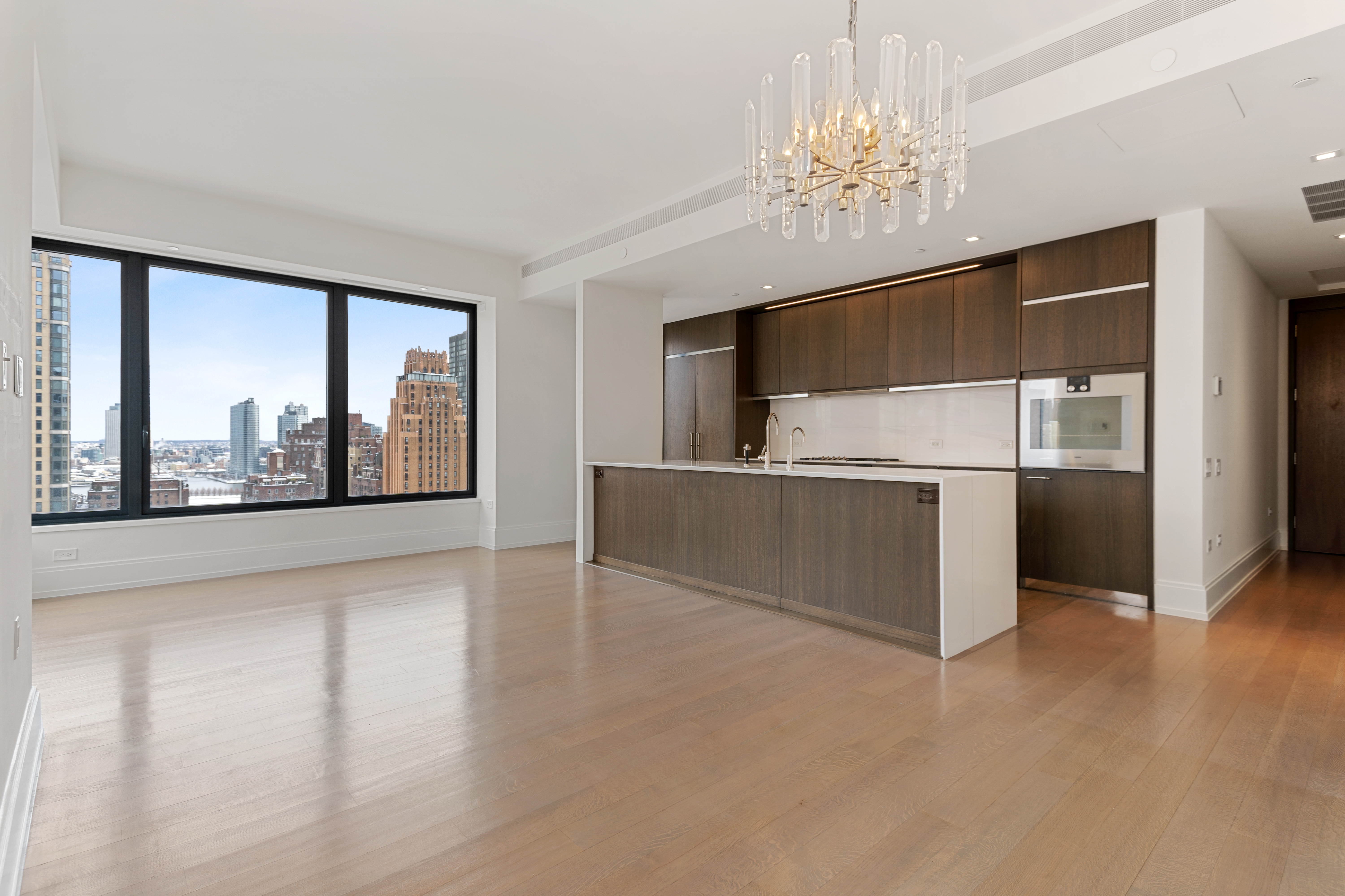 301 East 50th Street, Unit 17B Manhattan, NY 10022 - Photo 1 of 12 a view of a kitchen with microwave and refrigerator