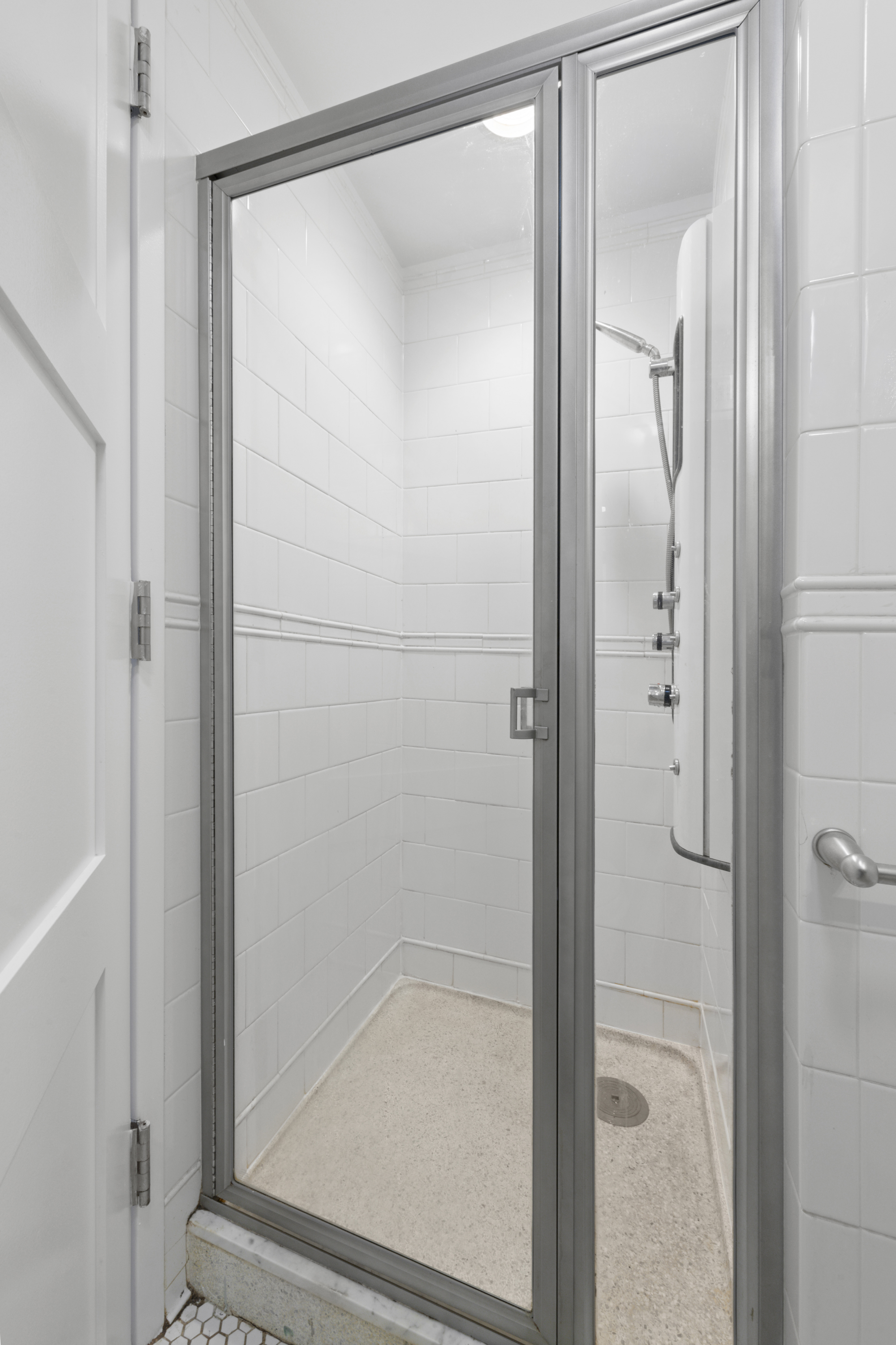 425 5th Avenue, Unit 23D Manhattan, NY 10016 - Photo 12 of 20 a bathroom with a glass shower door