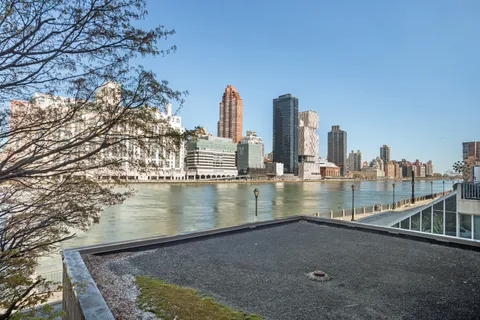 a view of swimming pool with outdoor seating and city view