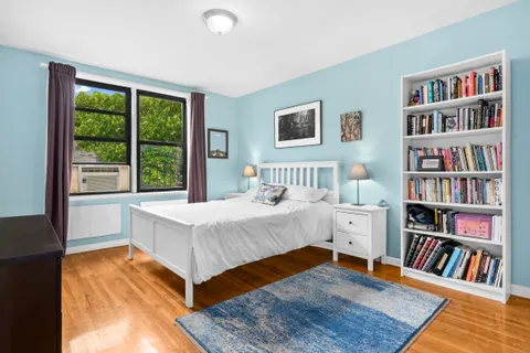 a bedroom with a bed and a book shelf