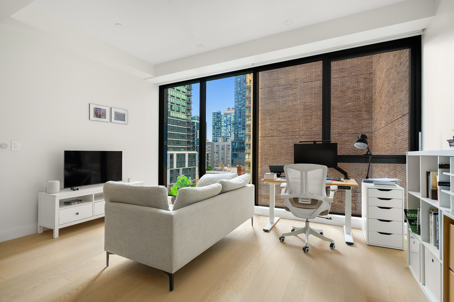 4507 Court Square, Unit 6G Queens, NY 11101 - Photo 1 of 6 a living room with furniture and a flat screen tv