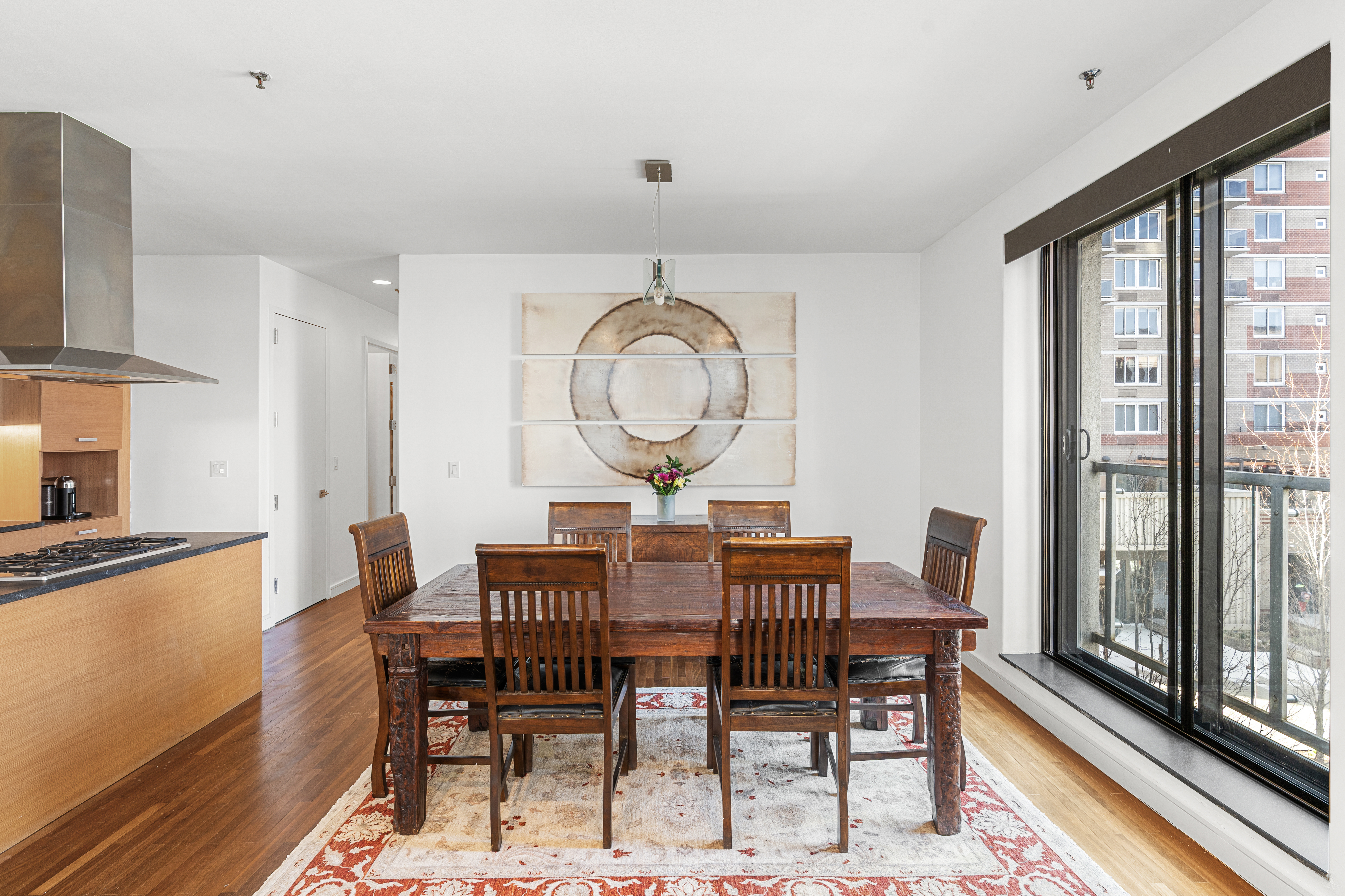 552 West 43rd Street, Unit 3A Manhattan, NY 10036 - Photo 3 of 11 a view of a dining room with furniture window and wooden floor
