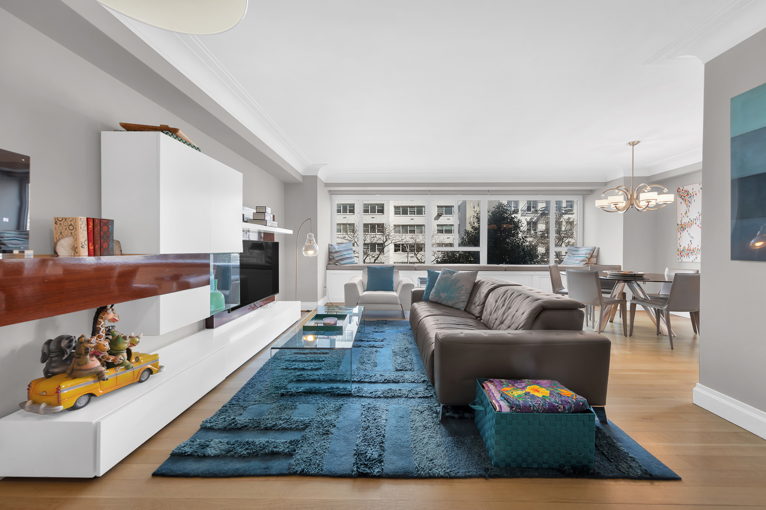 200 East 66th Street, Unit A407 Manhattan, NY 10065 - Photo 1 of 24 a living room with furniture and a wooden floor