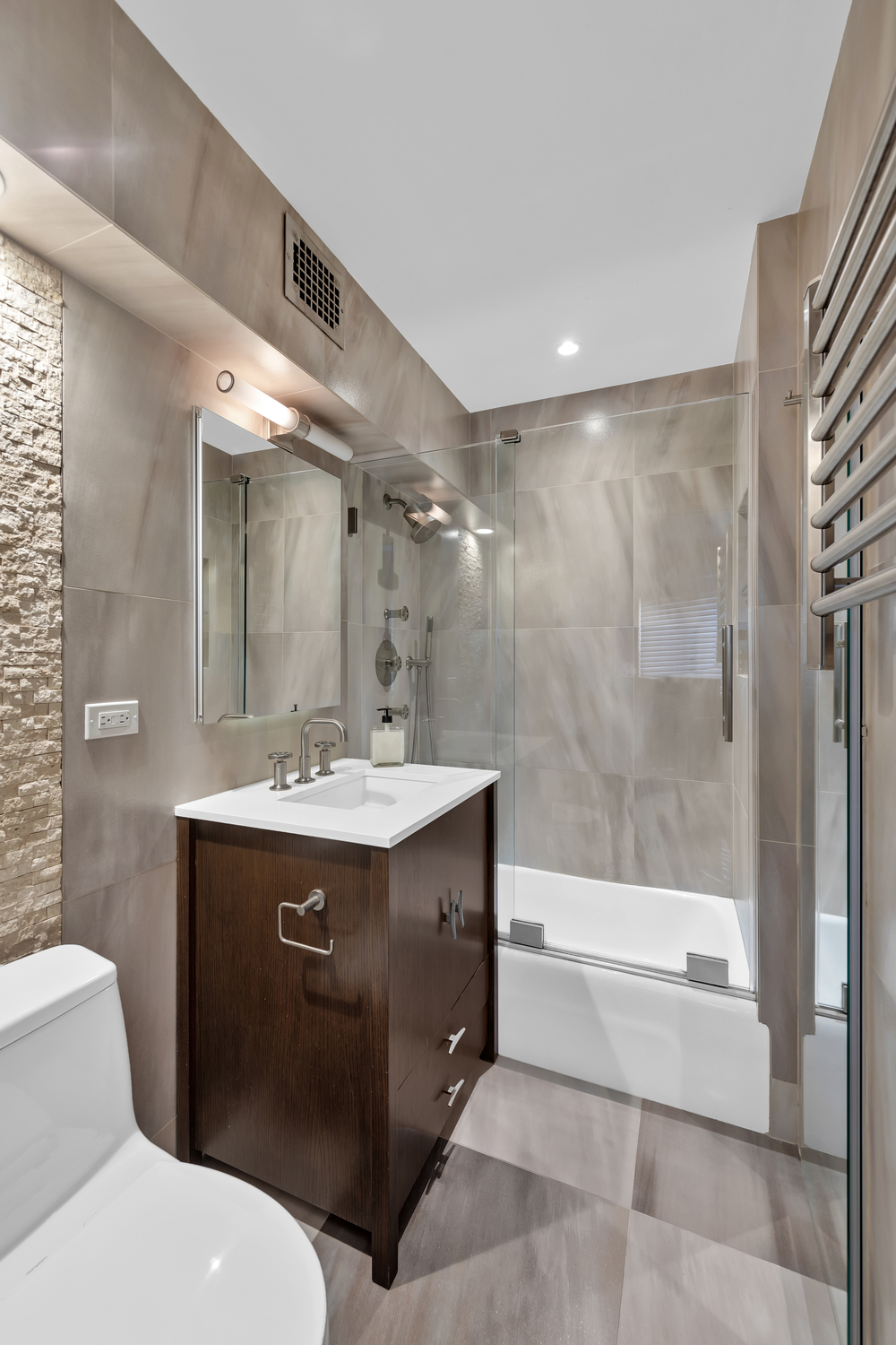 31 Jane Street, Unit 7A Manhattan, NY 10014 - Photo 7 of 11 a bathroom with a sink a toilet and shower