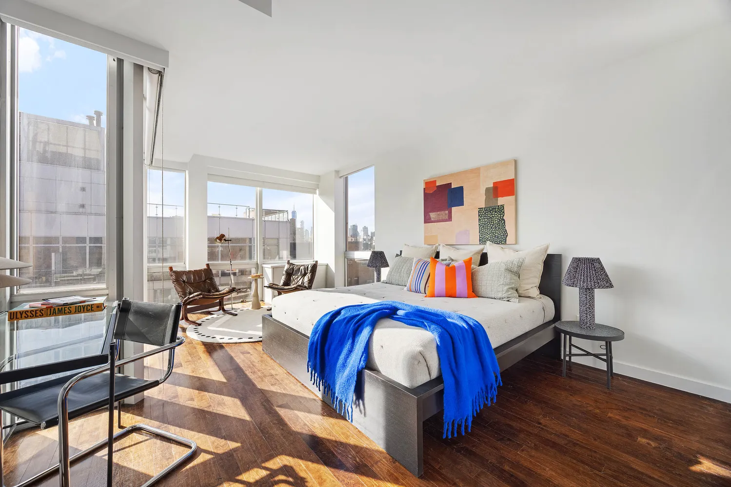 a bedroom with a bed and a large window