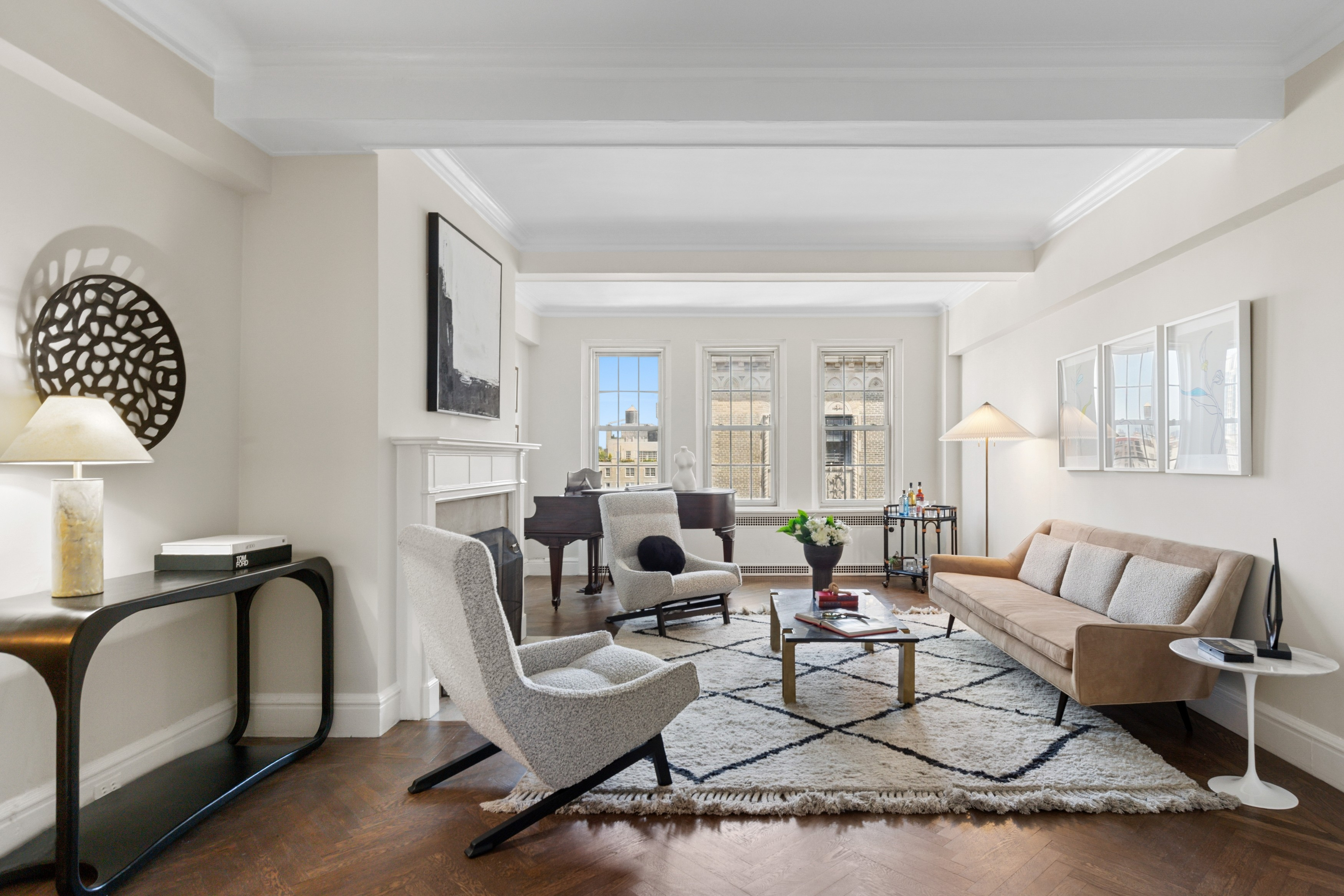 a living room with furniture a lamp and a potted plant
