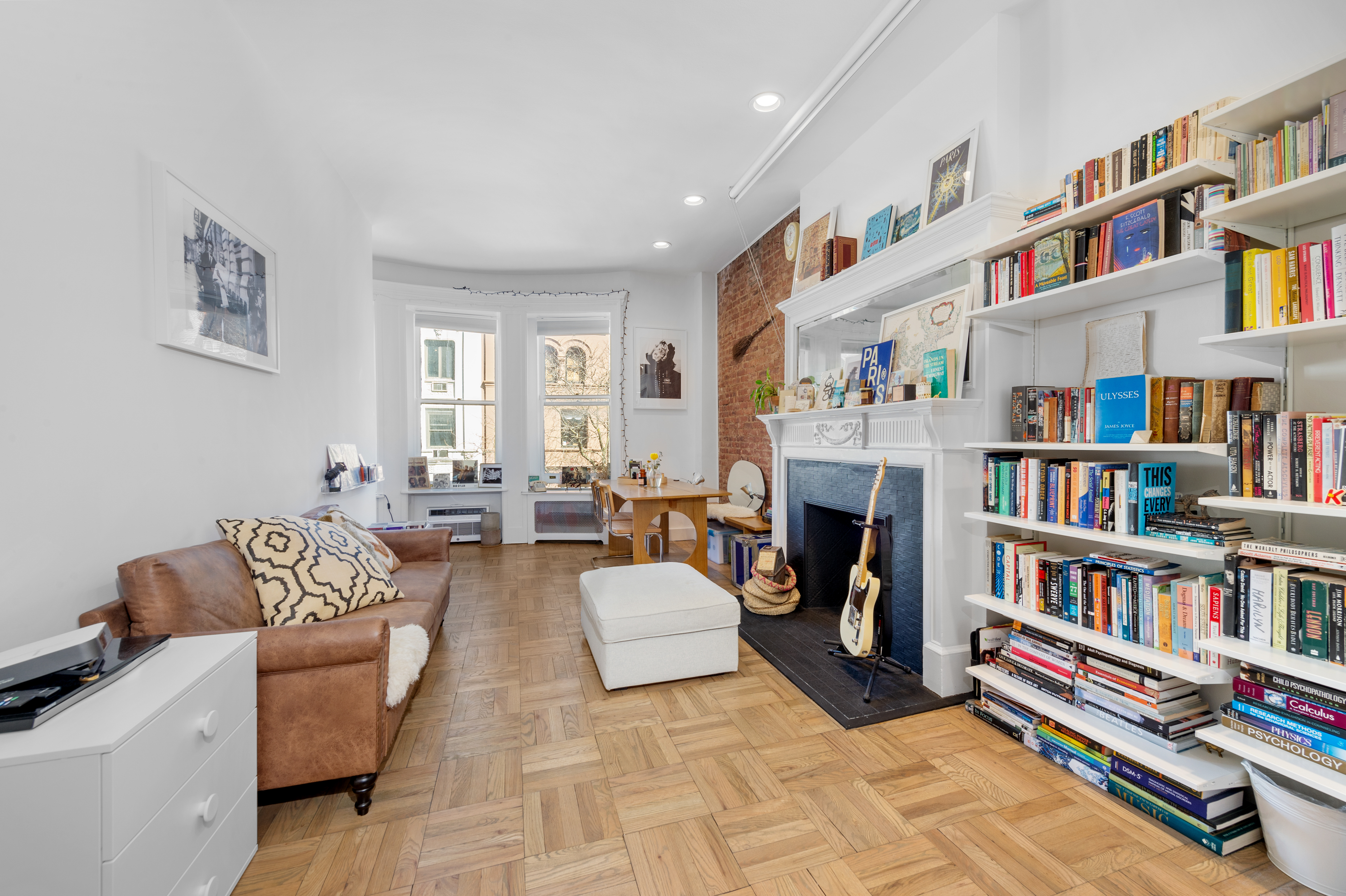 122 West 80th Street, Unit 3F Manhattan, NY 10024 - Photo 11 of 15 a living room with fireplace furniture and a book shelf