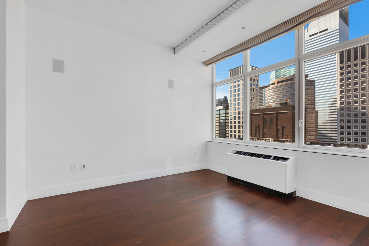 300 East 55th Street, Unit 28B Manhattan, NY 10022 - Photo 6 of 12 a view of an empty room with wooden floor and a window