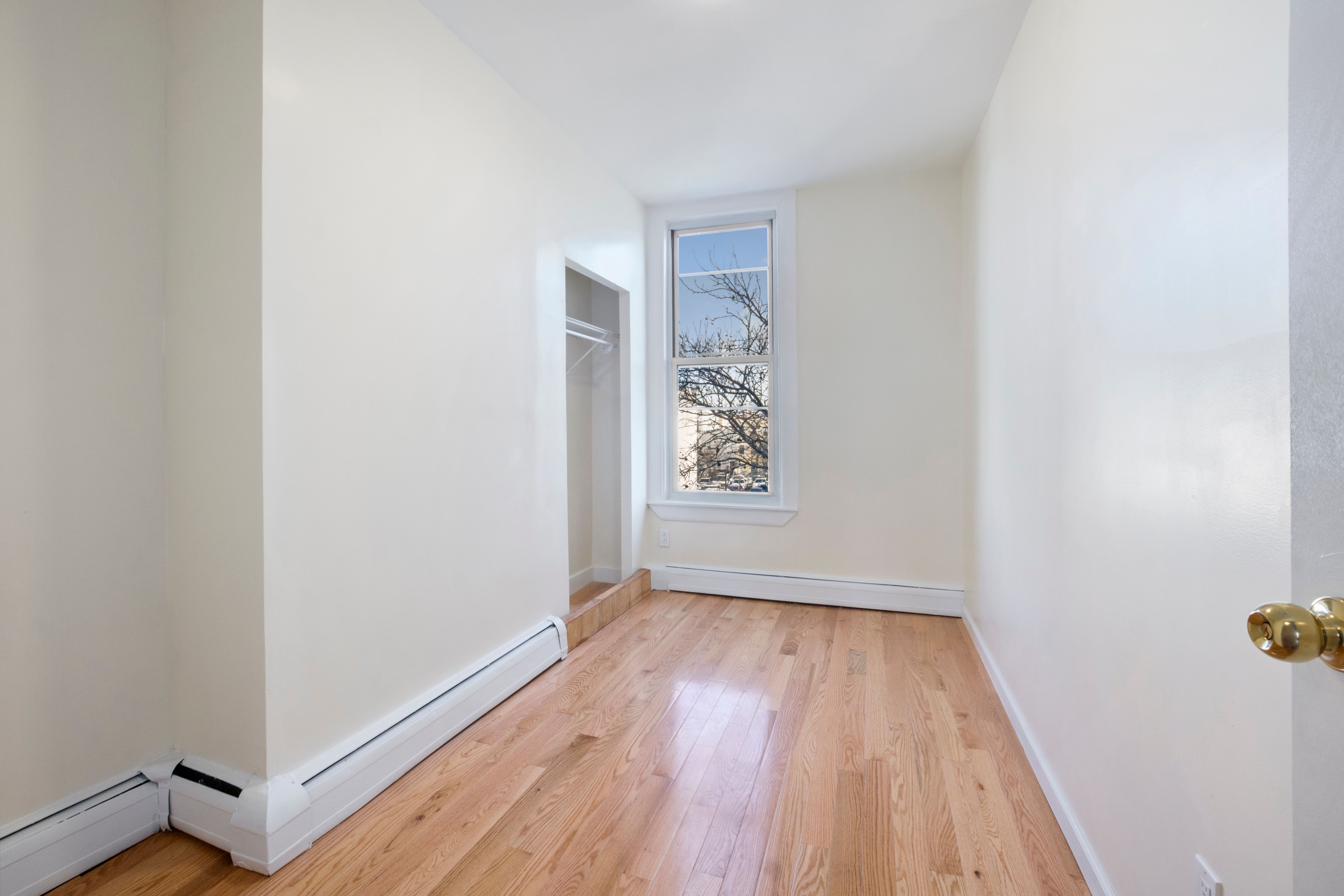 148 29th Street Brooklyn, NY 11232 - Photo 8 of 31 a view of an empty room with wooden floor and a window