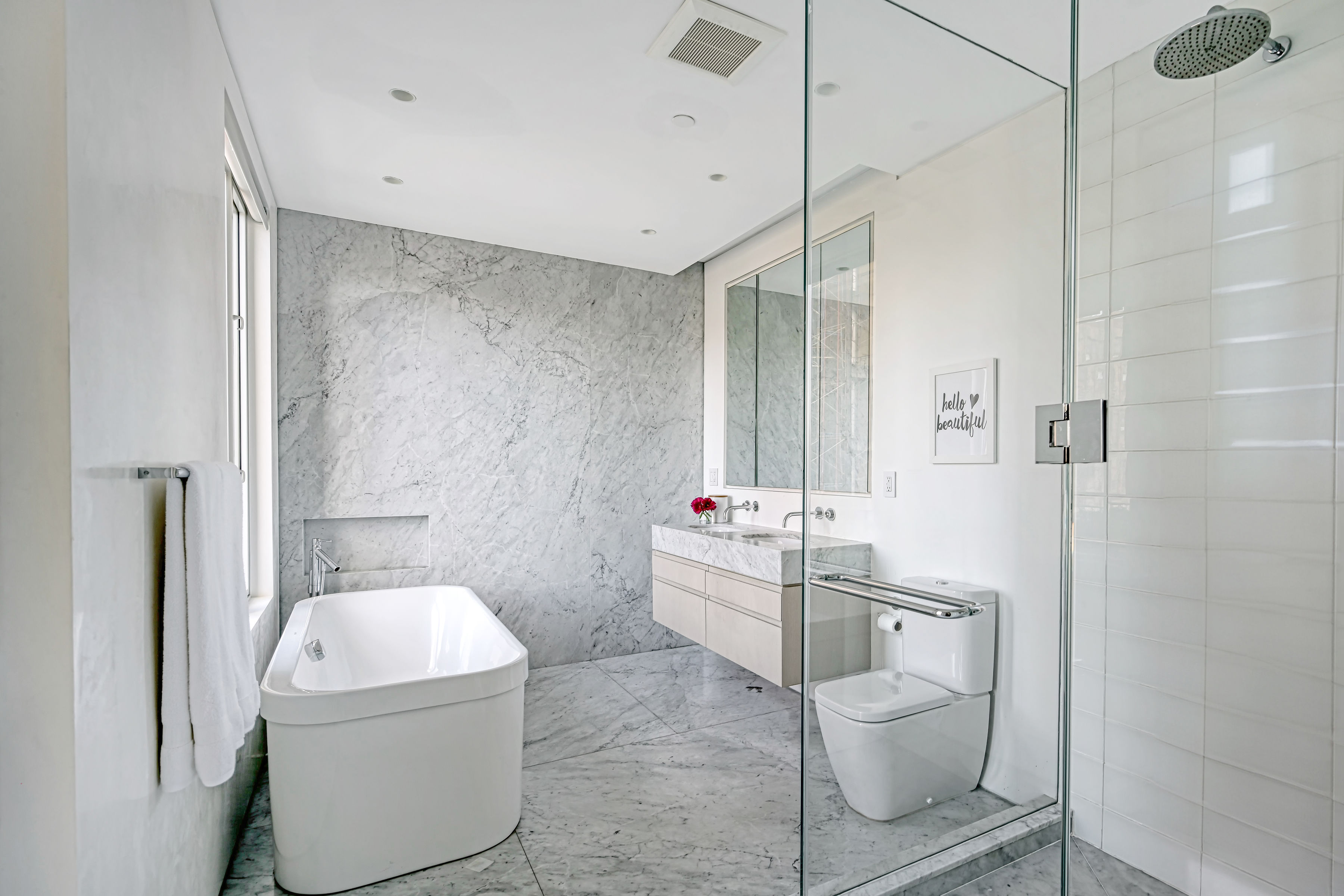 53 Leonard Street, Unit PH Manhattan, NY 10013 - Photo 20 of 24 a white toilet sitting next to a bathroom sink